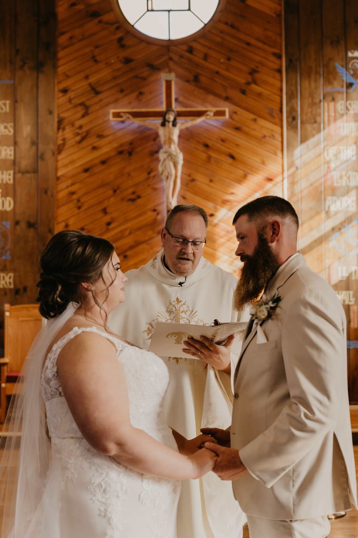 Couple exchanging vows during ceremony on their wedding day.