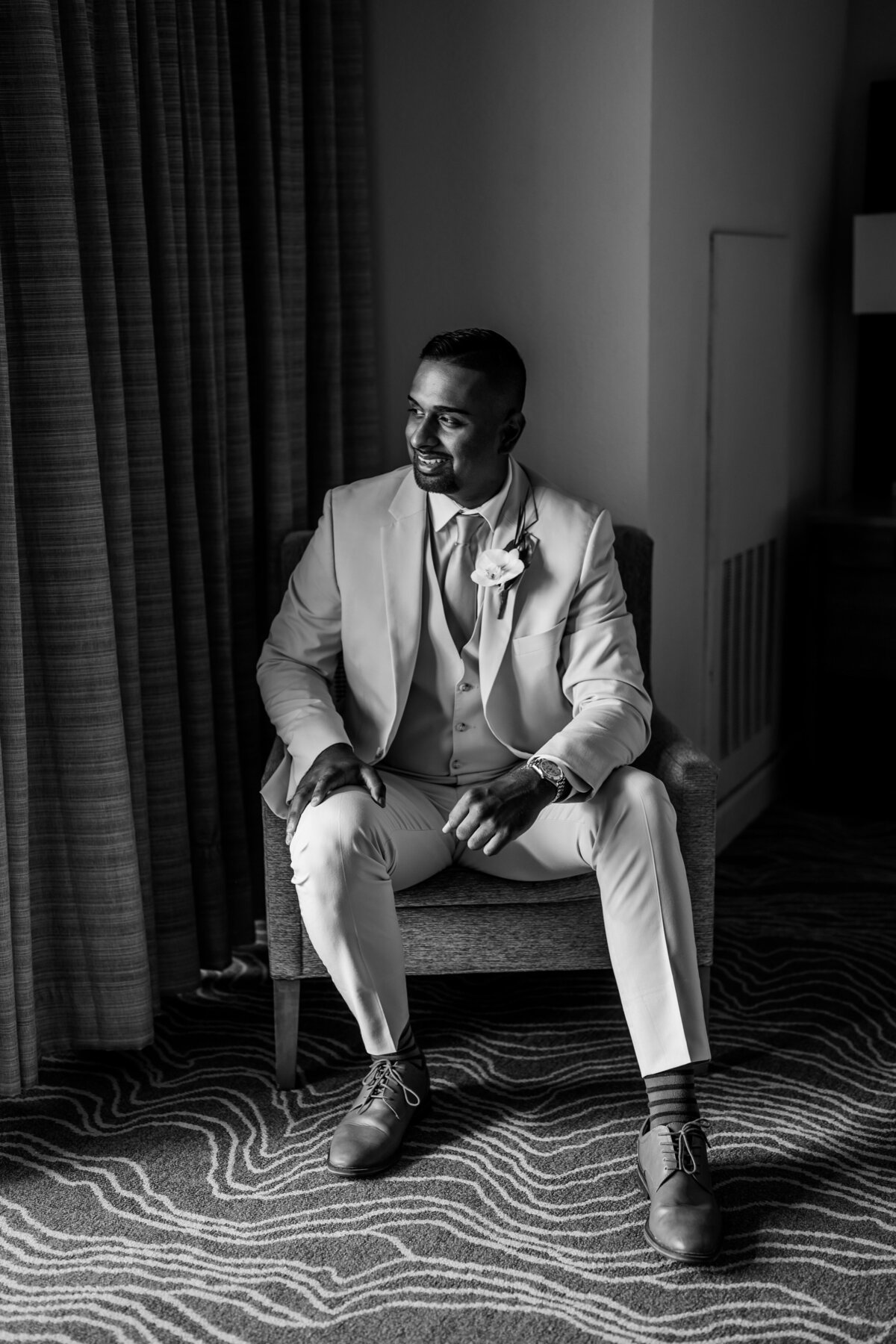 groom taking a minute after he gets dressed in suit before wedding ceremony