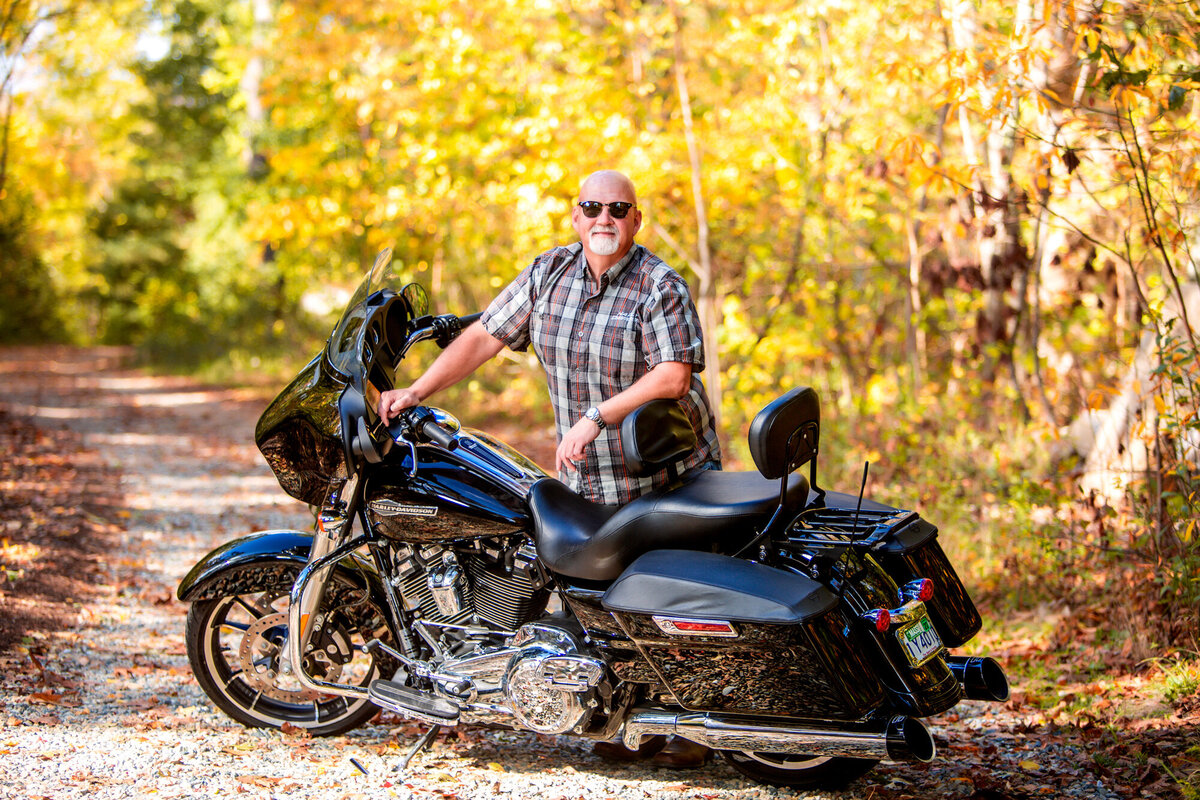 A male dating portrait client showing off his Harley-Davidson