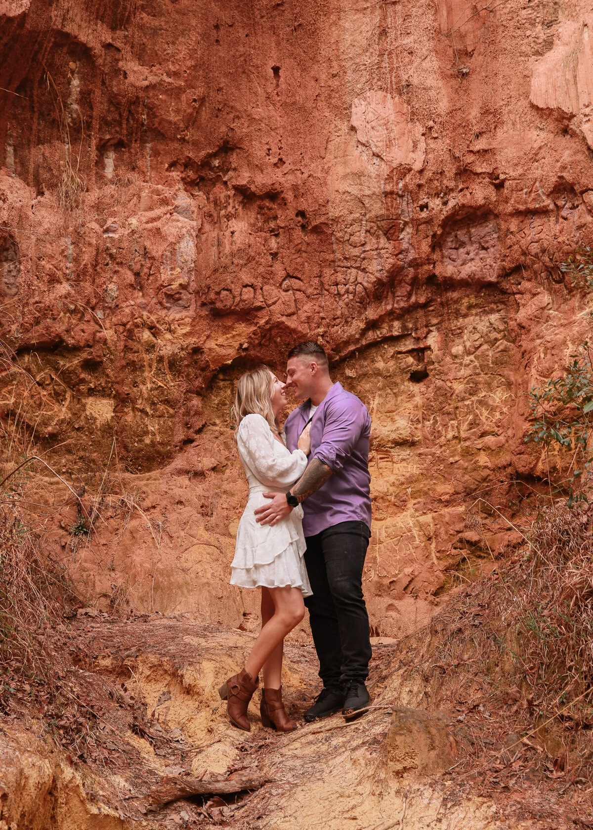 engaged couple wearing white and purple at Providence Canyon State Park  close to Columbus Georgia by Columbus Georgia engagement photographer Amanda Richardson Photography