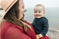 fallback shared on Invalid Date | a woman holding a baby in her arms. in Falmouth Massachusetts
