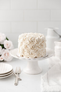 fallback shared on Invalid Date | a cake decorated with white buttercream roses