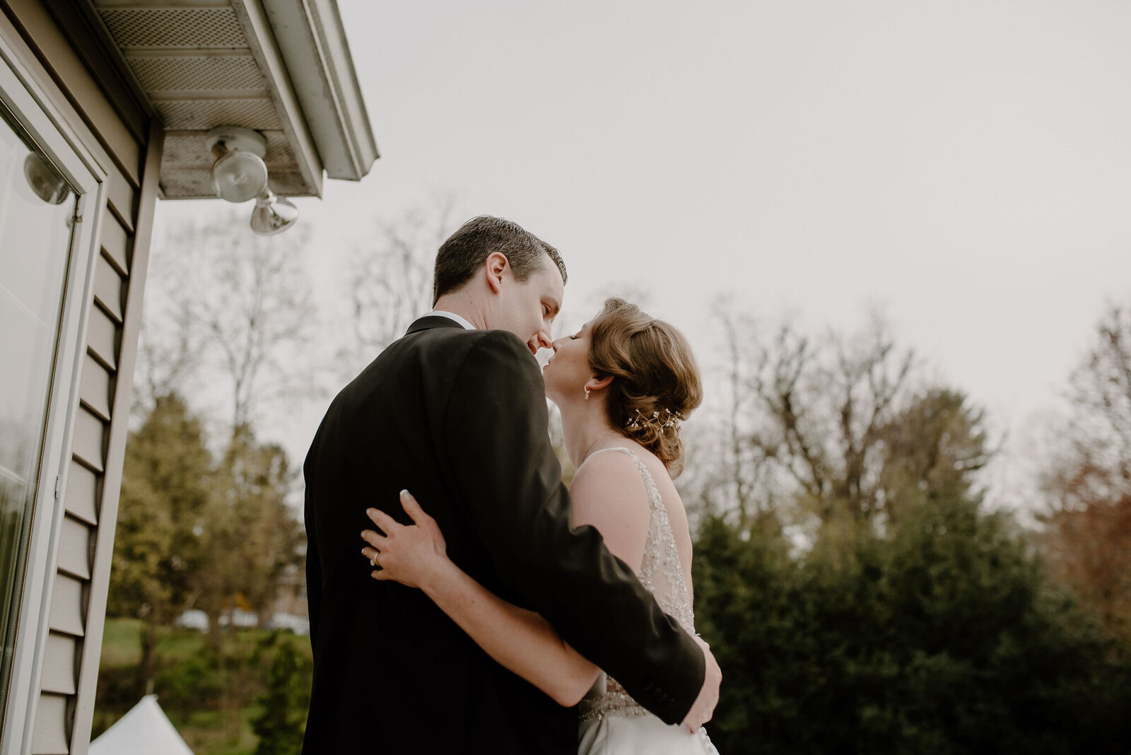 couple kissing on porch winter outdoor wedding