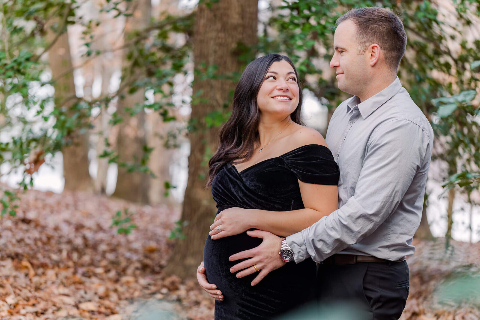 A couple lovingly looking at each other during their maternity session in Burke, VA.