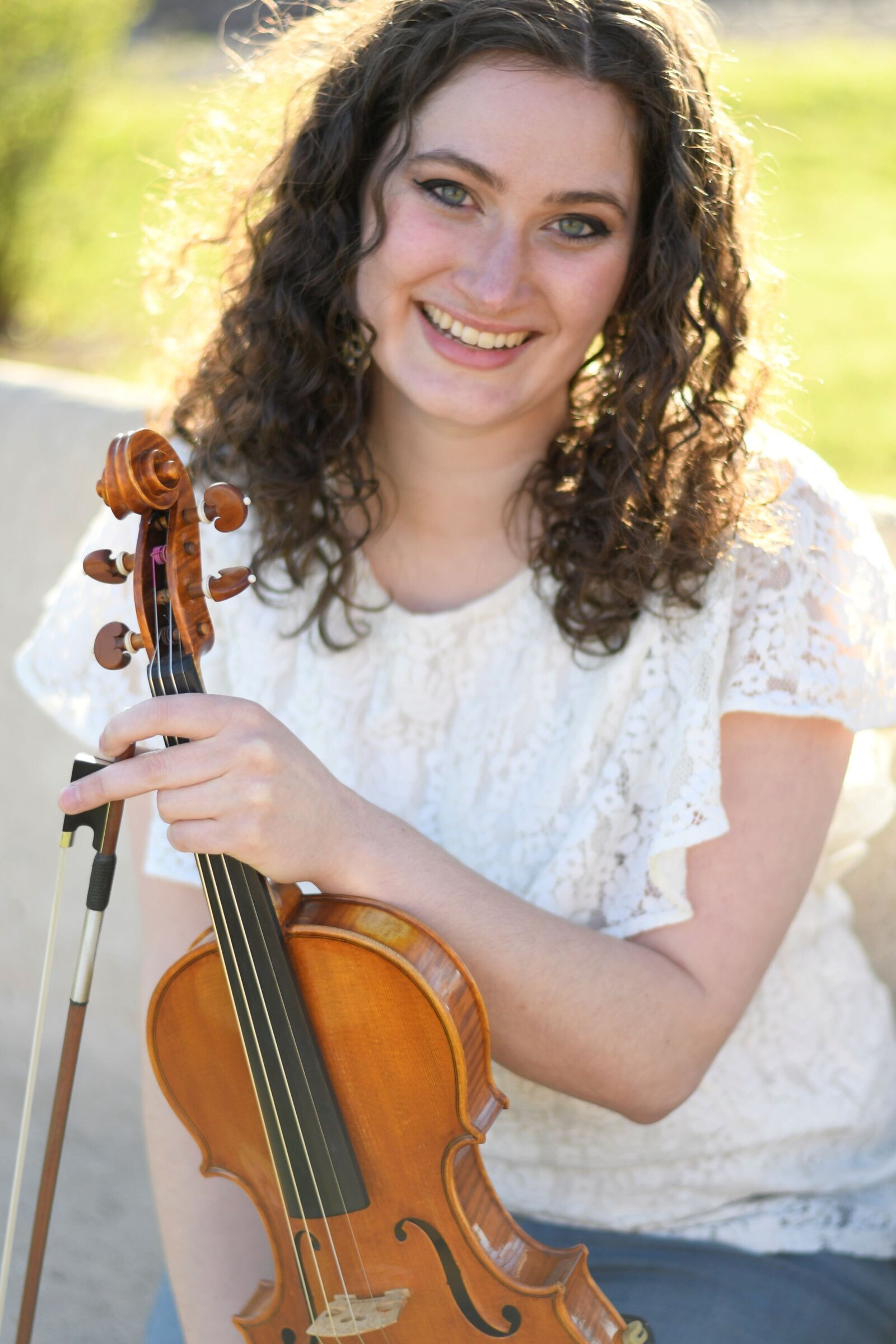 Franklin Method Educator and violinist Erika Burns smiling with her violin.