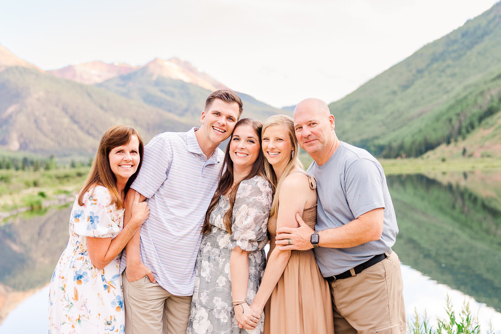family of 5 poses in front of crystal lake colorado