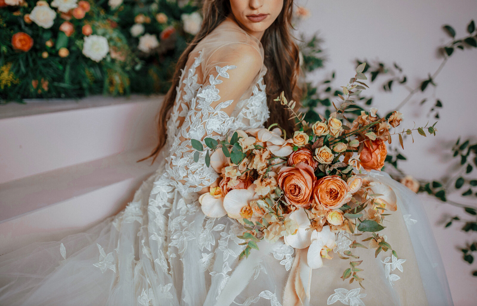 Close-up editorial bridal portrait featuring a modern bride in a lace gown with a lush orange-toned bouquet, styled for a luxury wedding in South Carolina.
