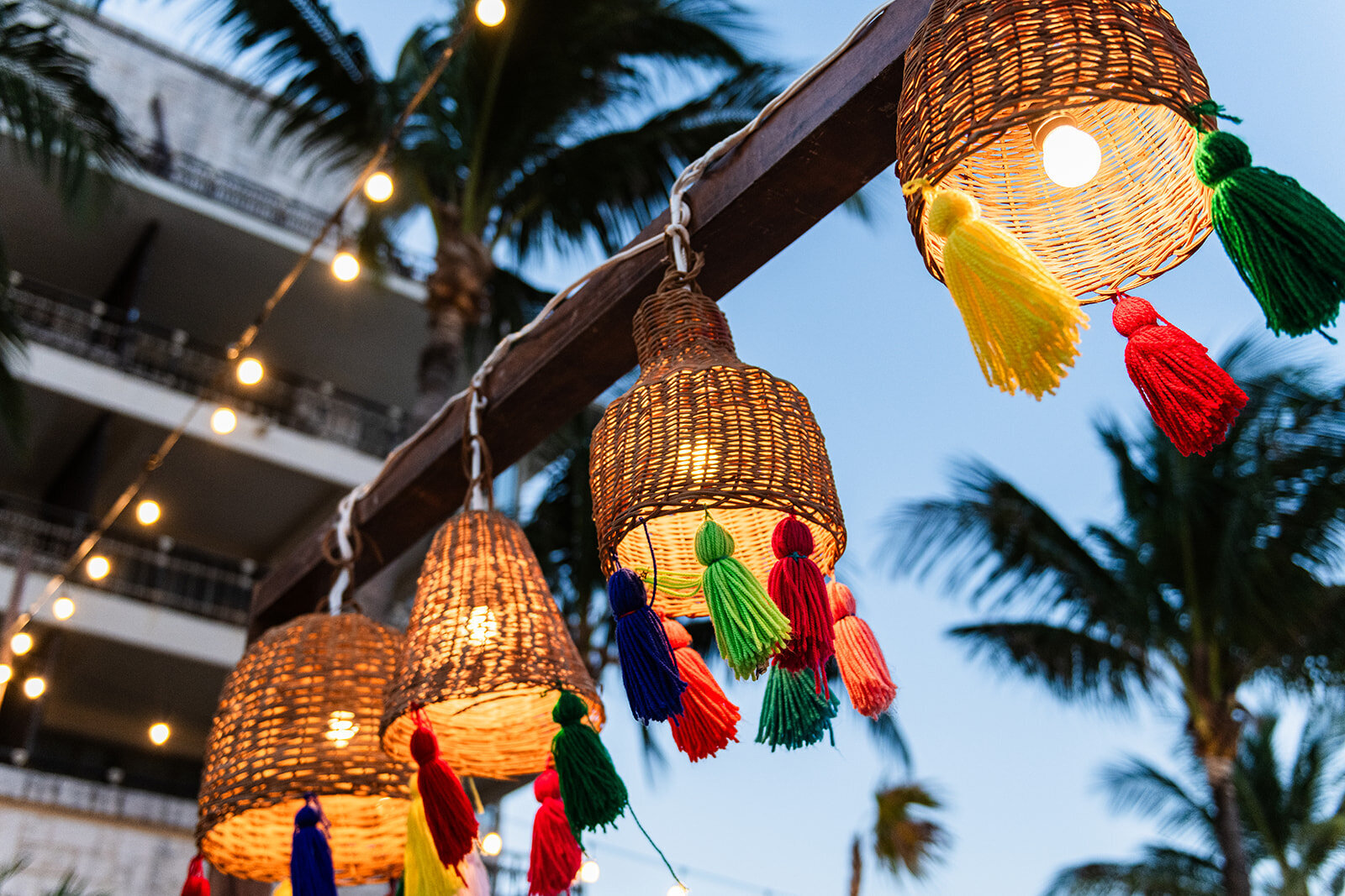 Vibrant and festive wedding lanterns hanging from trees, captured in a unique outdoor wedding setup by CMH Studios in San Antonio.