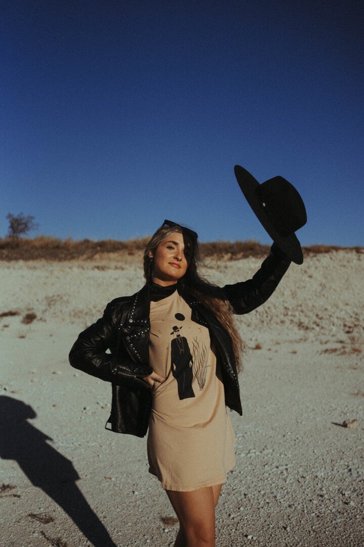 Model blocks the sun with her cowboy hat