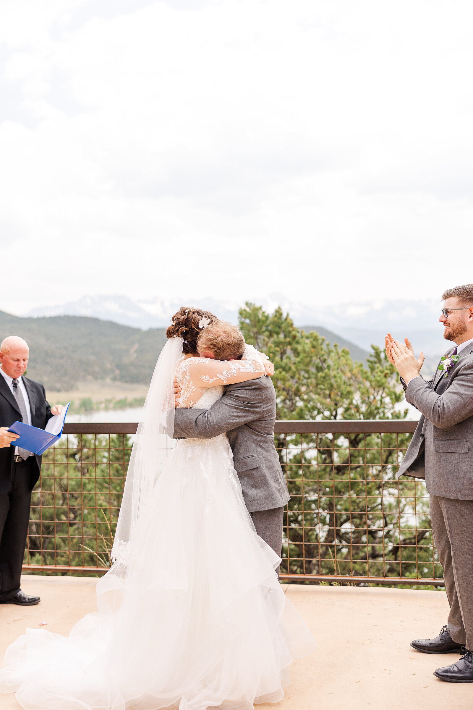 Bride and groom embracing and sharing a joyful kiss right after saying 'I do' at their Ridgway State Park wedding.