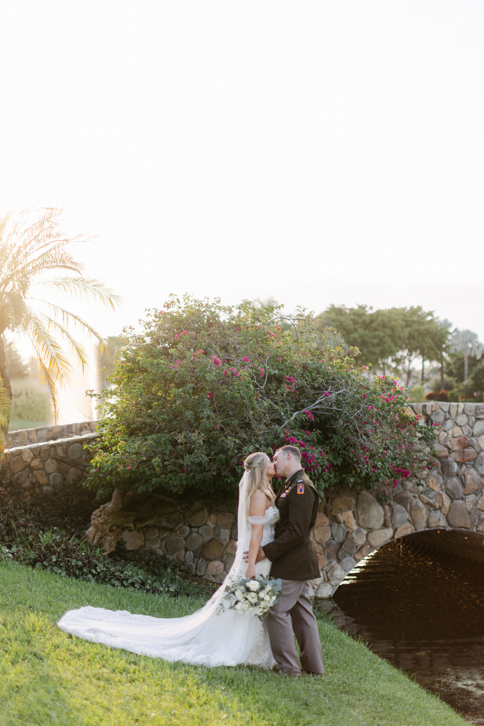 Bride and Groom embrace in a kiss near this elegant bridge in Palm Beach, Florida. Photo by Maggie Alvarez Photography