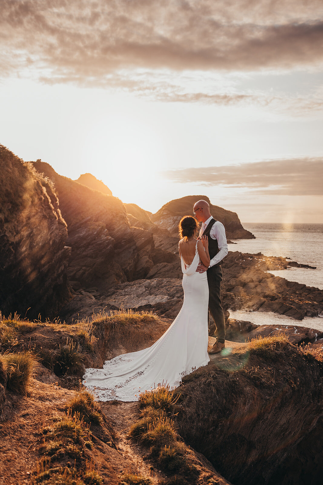 married couple pose on cliffs