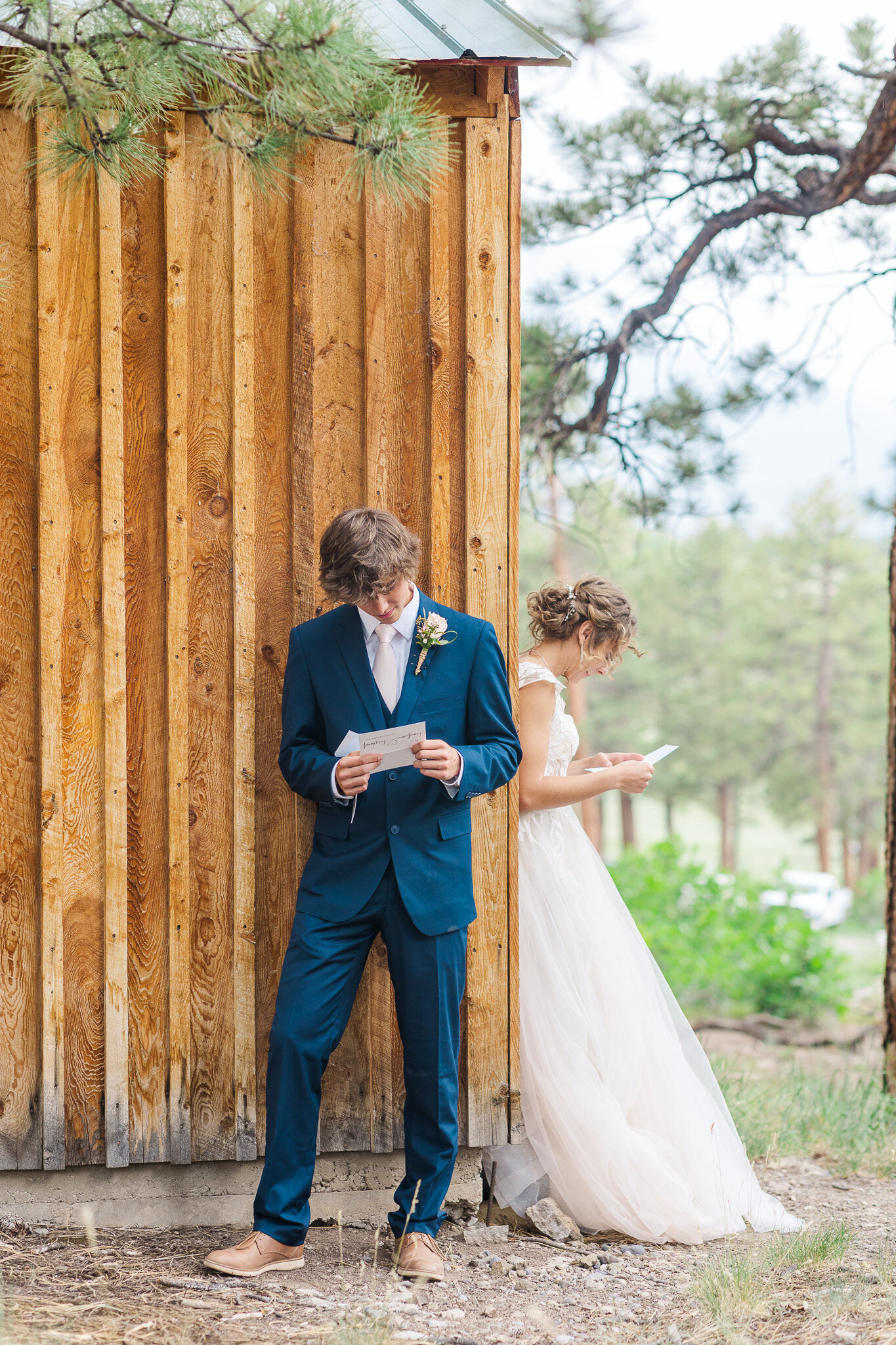 bride and groom both reading letters they  wrote to eachother before the wedding