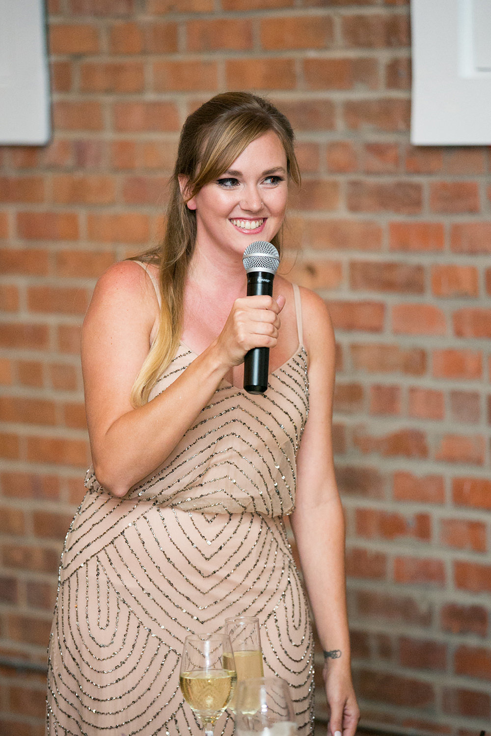 couple laughing at reception speeches brick