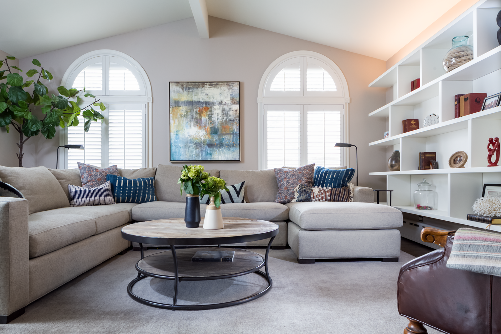 Neutral decorated living room with white built in shelves