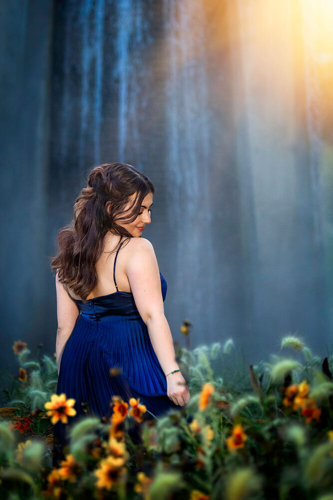 artistic-waterfall-senior-girl-flowers-rich-jewel-tones-complimentary-colors-blue-marigold-sapphire