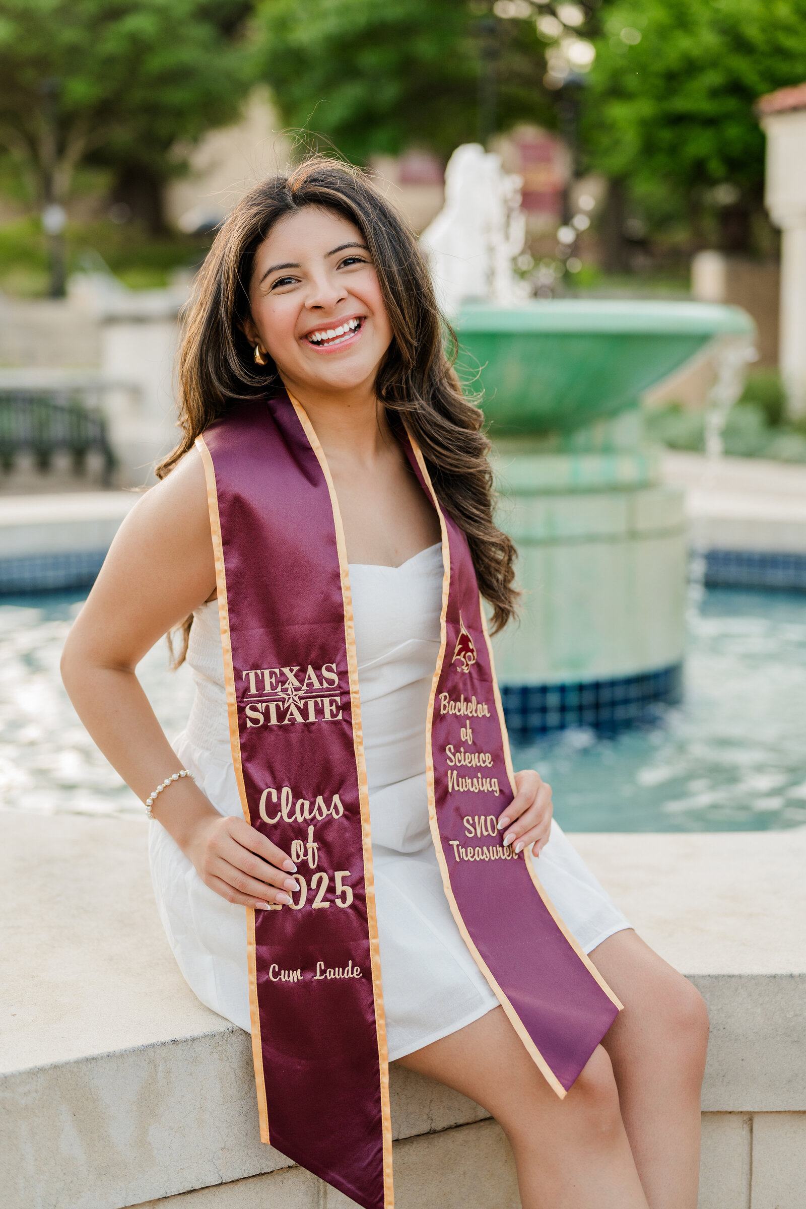 Texas State graduation photos by the fountain 