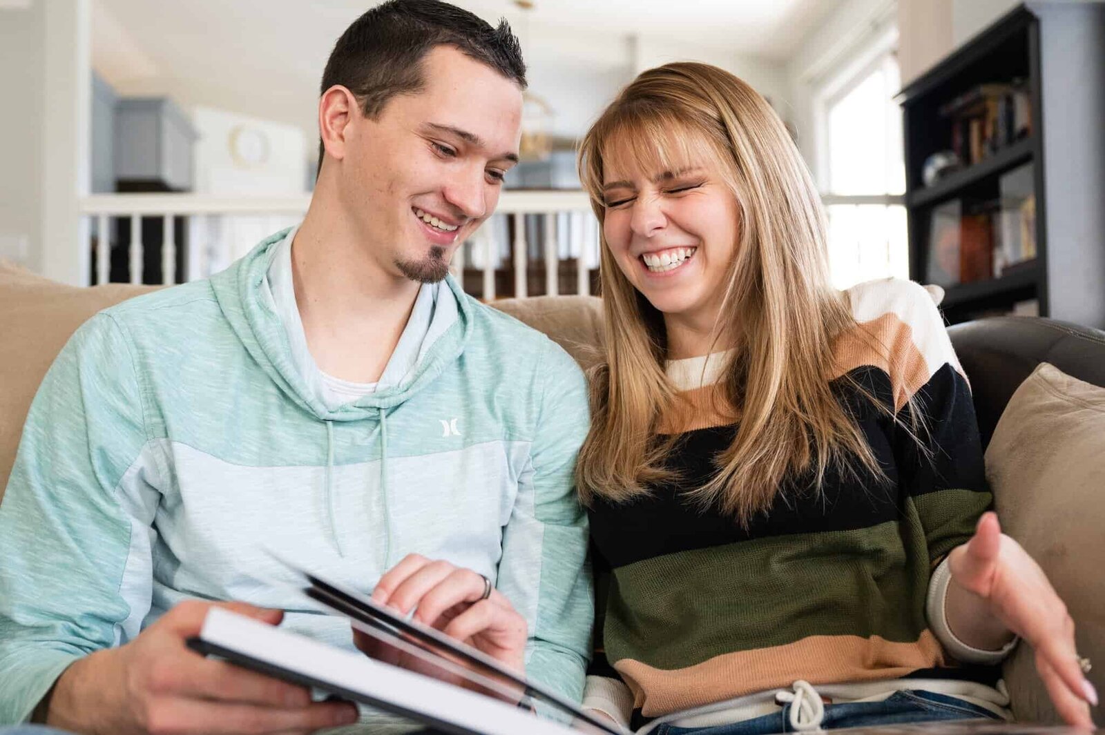Couple shares a laugh while looking through their wedding album.
