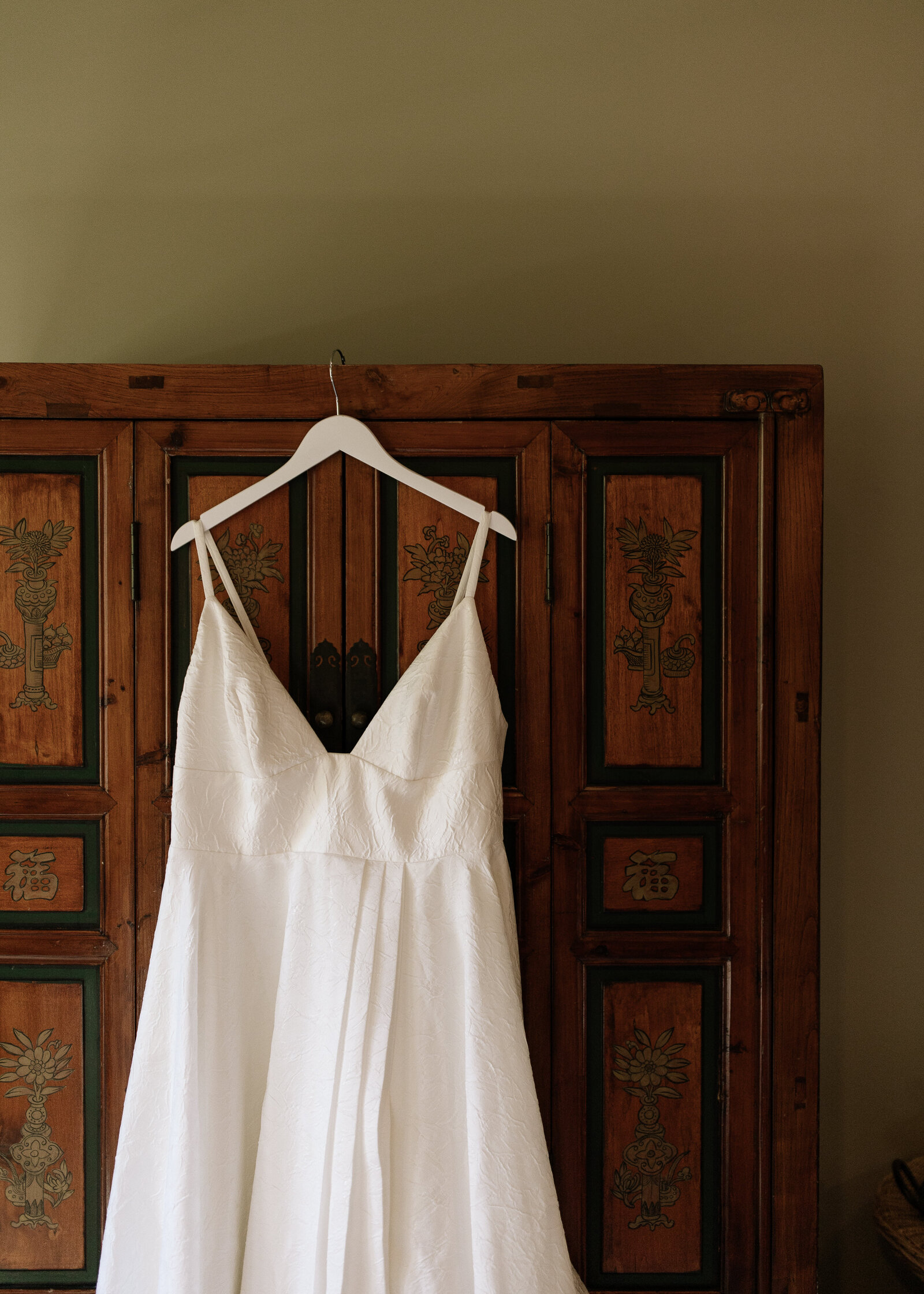 Dress hanging on wardrobe in bridal suite at Dawn Ranch Lodge in Guerneville, CA