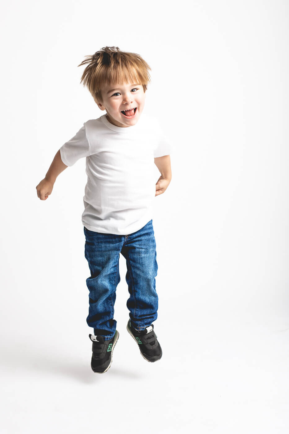 Young boy in white shirt jumping for Tampa photographer