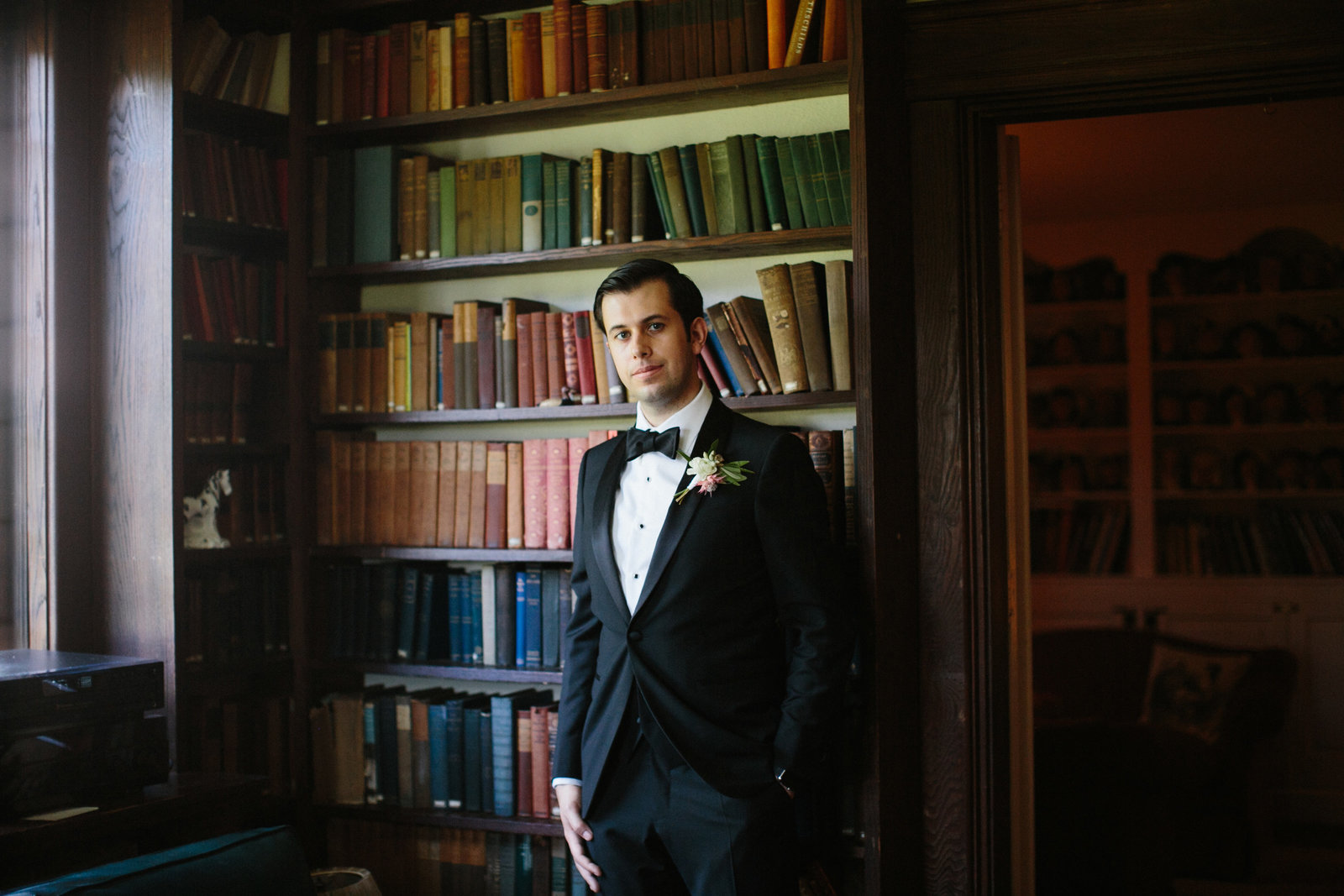 Groom photographed in the library of this historic Bed and Breakfast at Fernbrook Inn.