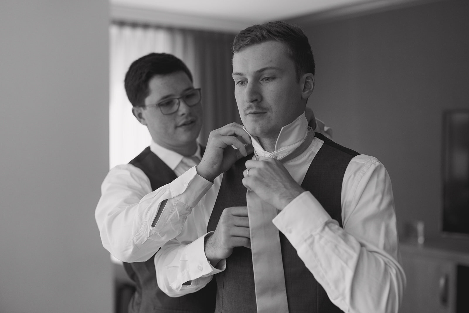 groom-getting-ready-tying-tie