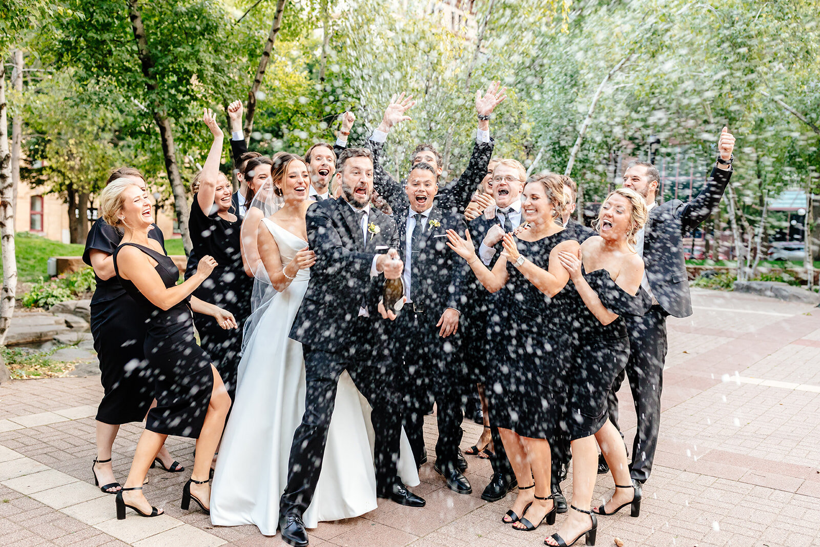 wedding-party-popping-champagne-outdoor