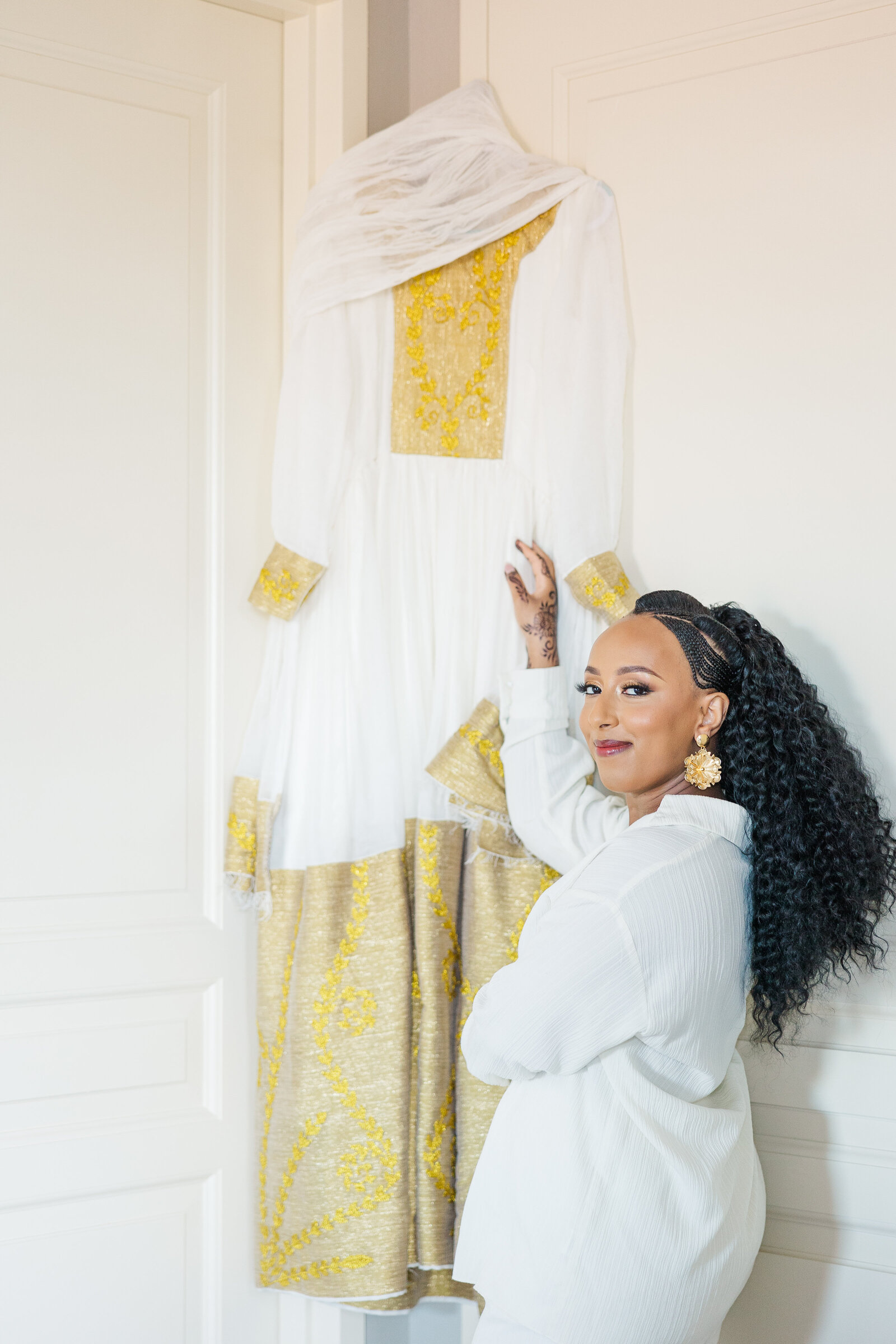 Bride holding wedding dress during getting ready shots at the bridal suite