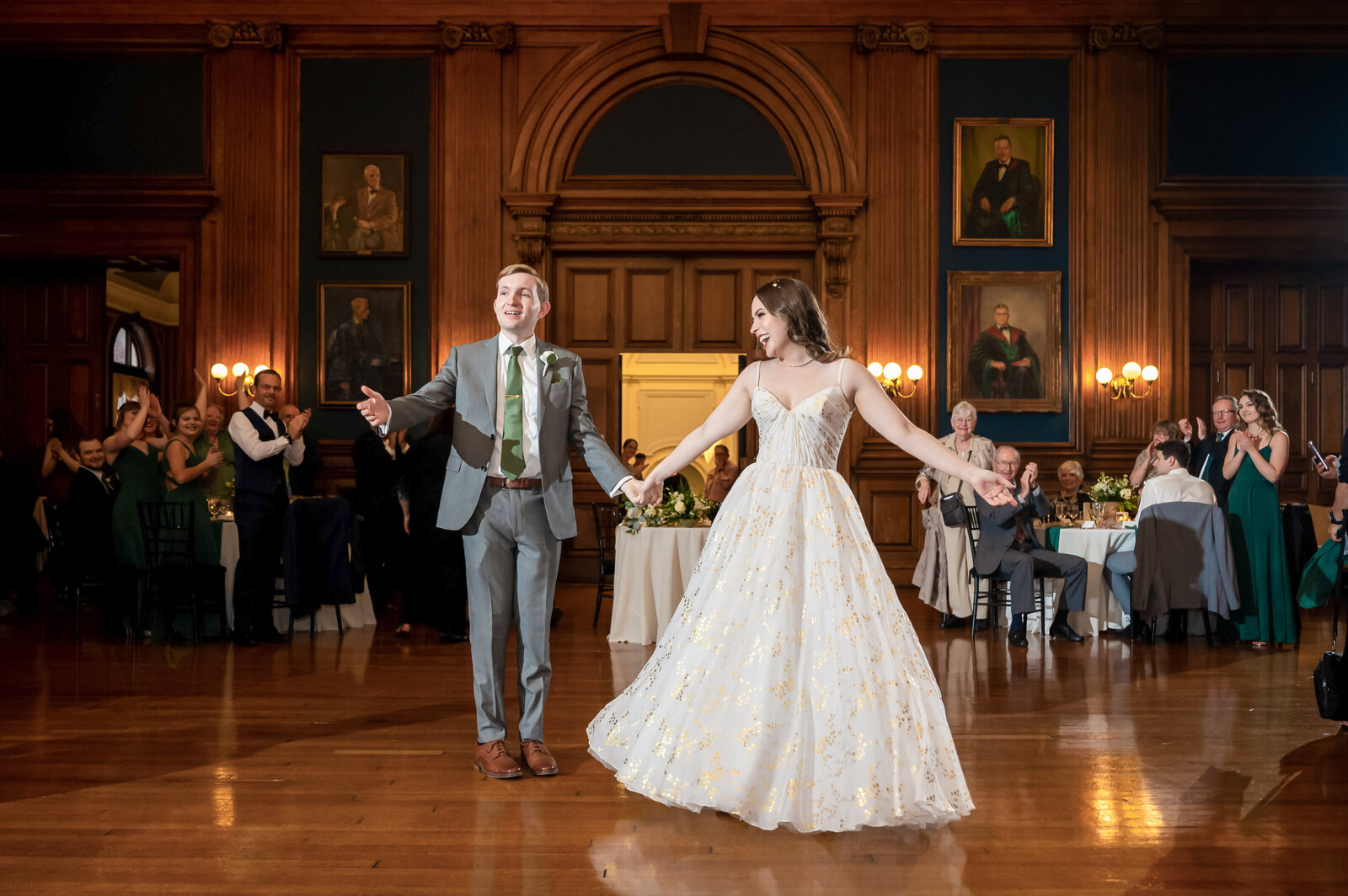 Bride and groom, holding hands while entering their wedding reception at the college of physicians in Philadelphia, Pennsylvania