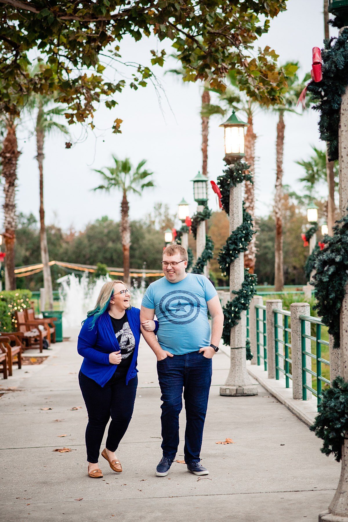 Pat and Mahlia walking in park near Disney World at Christmas wearing Marvel shirts