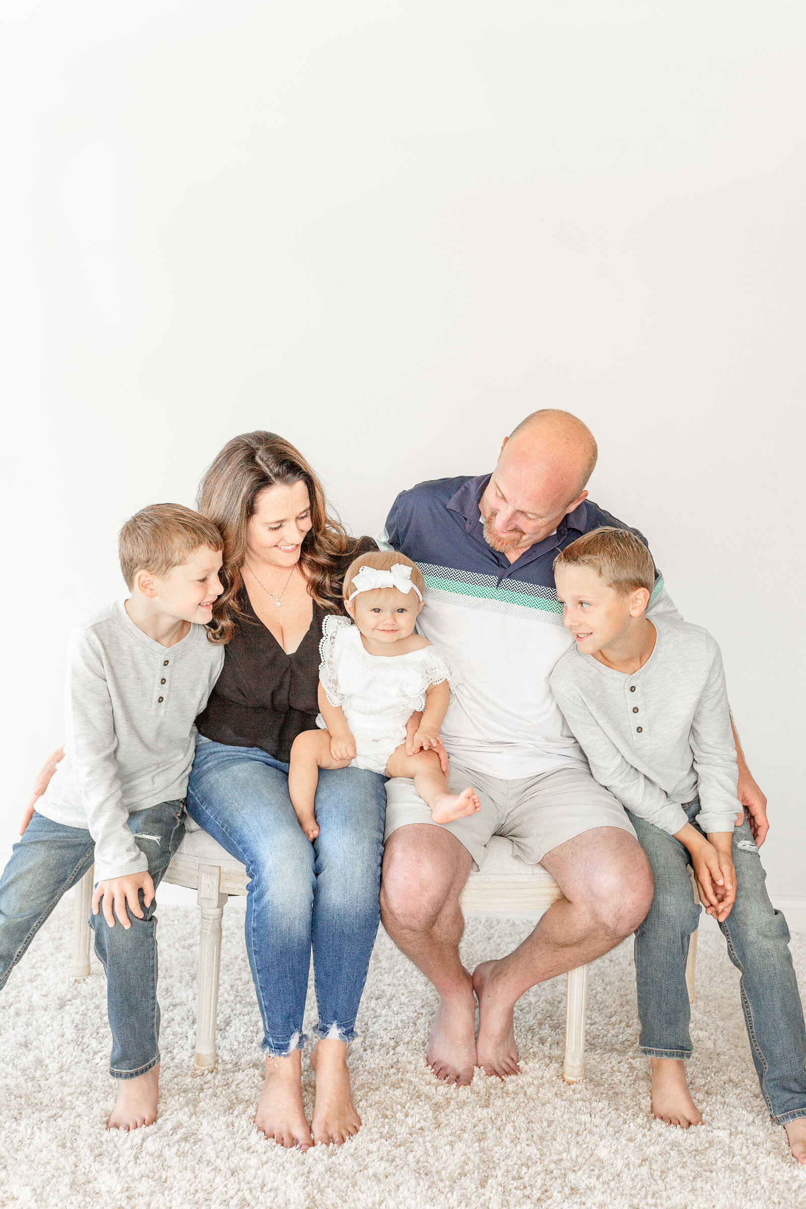 Studio Neue hosts family of 5 for baby girl's first birthday cake smash session.  Photos taken by Plymouth Michigan Newborn Photographer