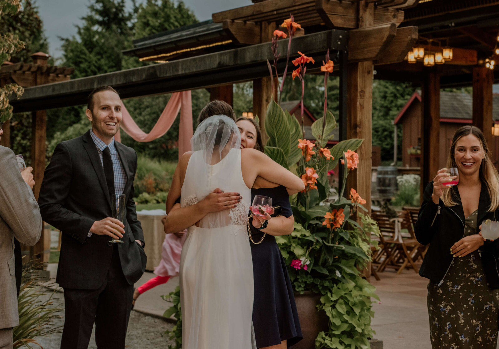 Bride hugging friends after ceremony.