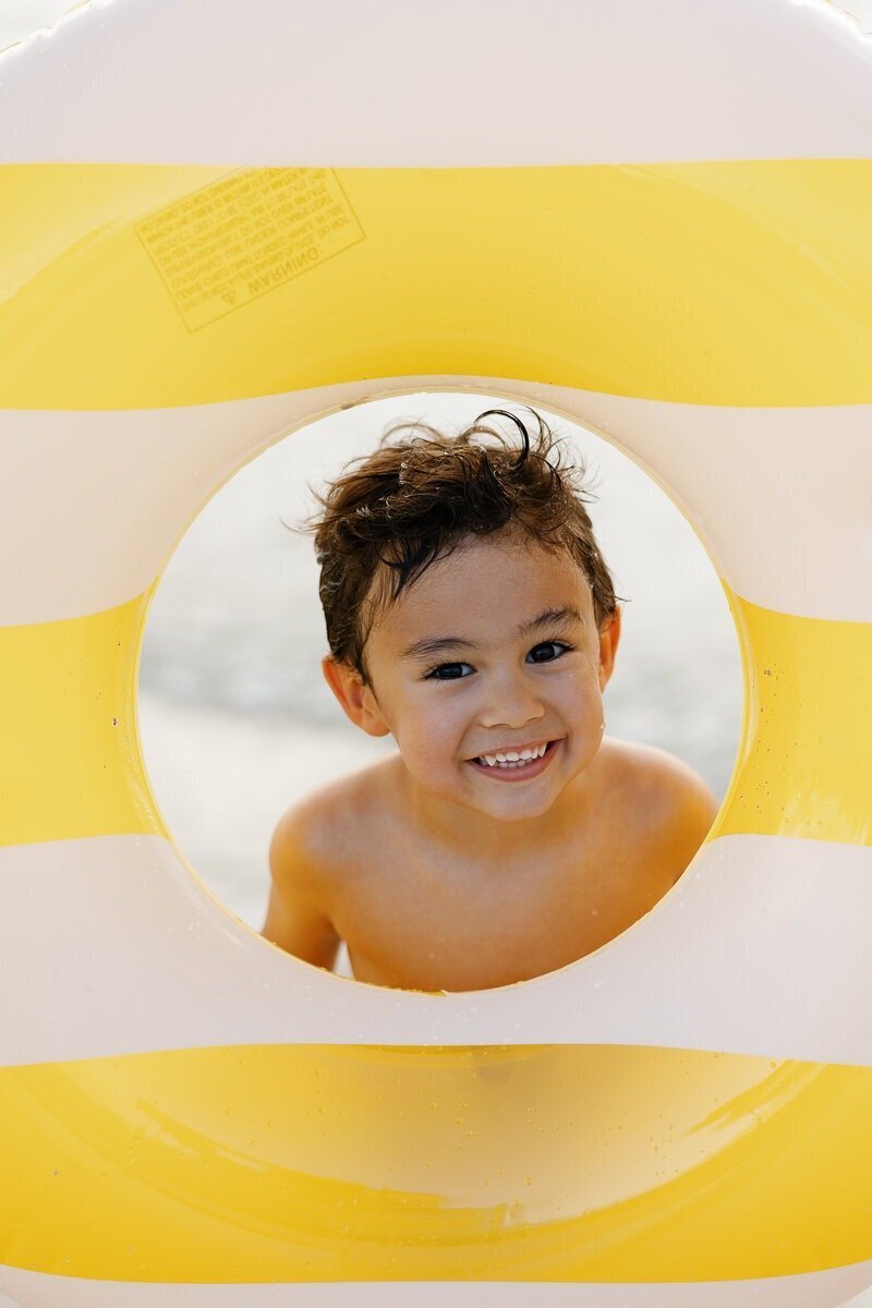 boy playing with inntertube taken by family photographer naples fl
