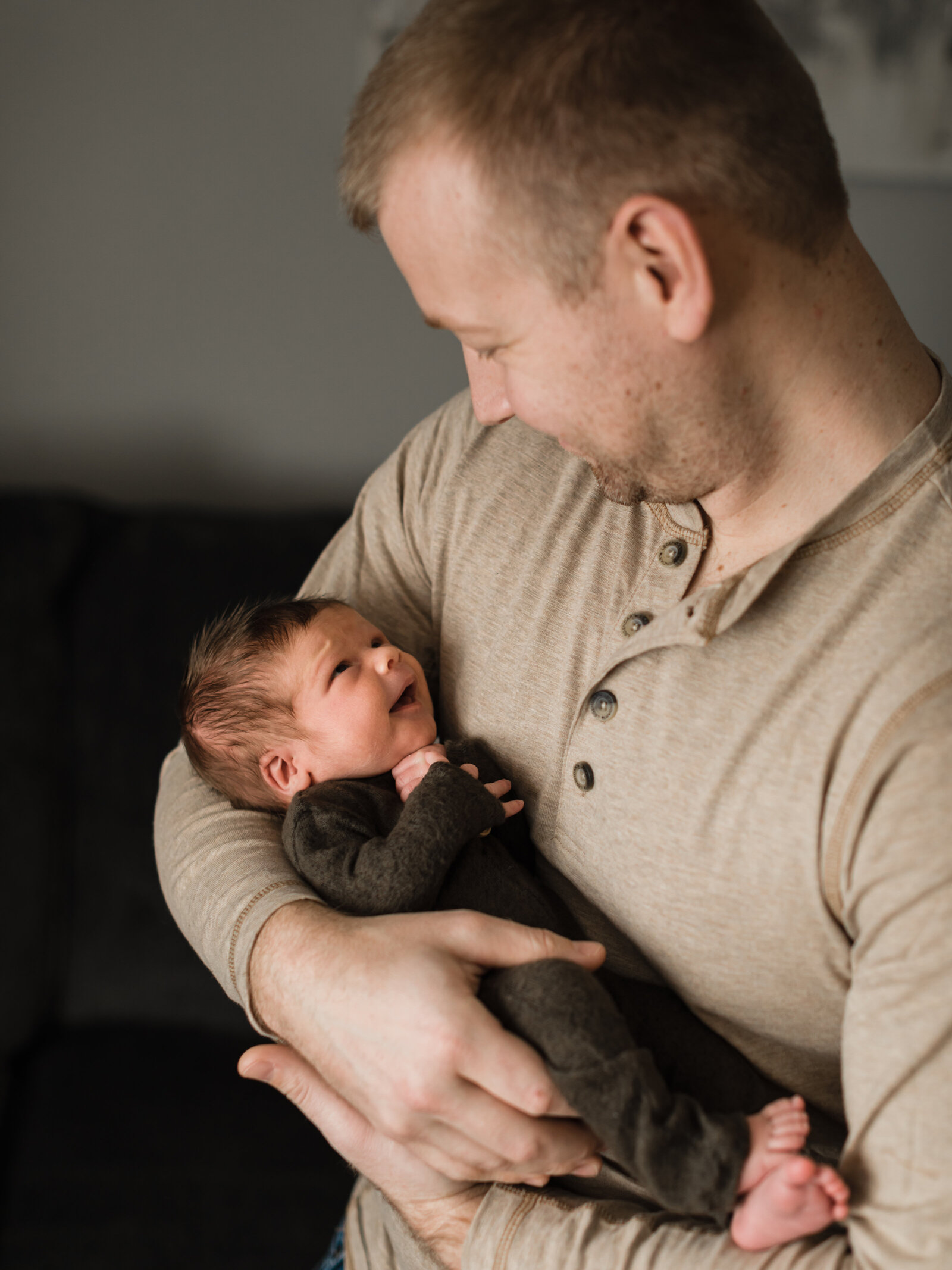dad holding newborn baby boy for in home lifestyle session