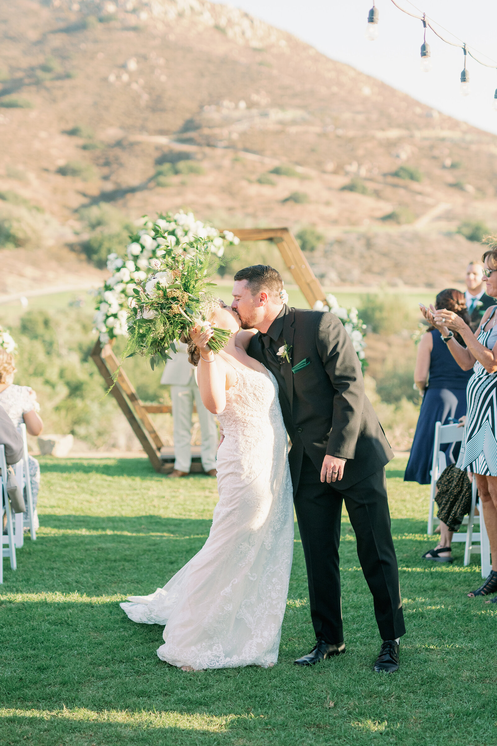 Bride and groom kiss at alter temecula photography