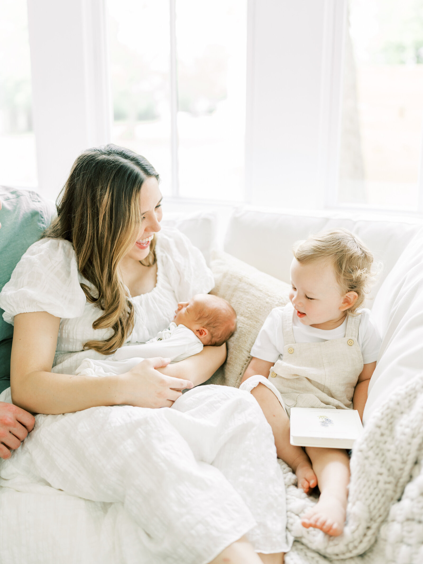 mom with newborn and toddler sibling