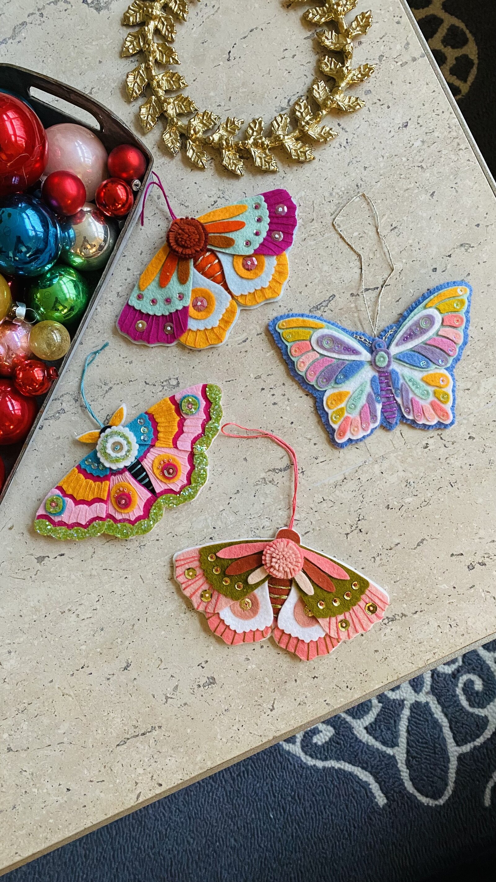 Hanmade butterfly and moth ornaments out of felt and sequins and beads.