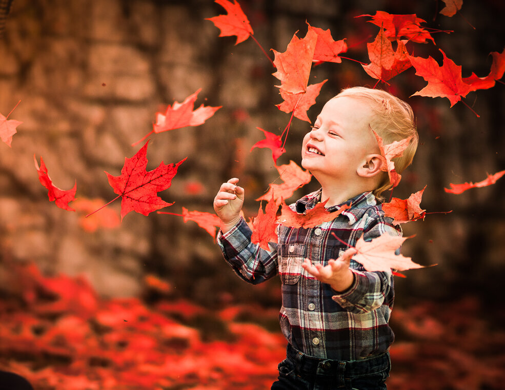 boy-throwing-red-leaves-fall-photoshoot