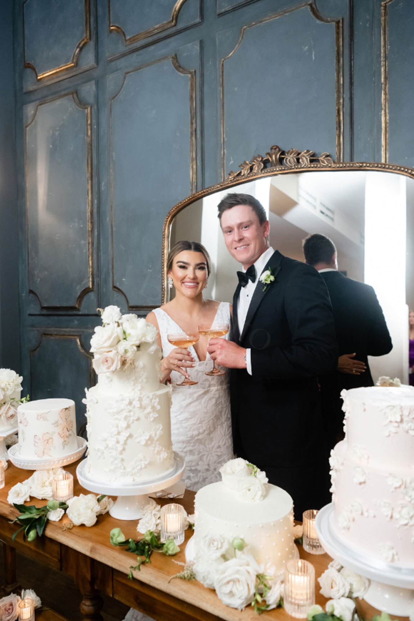 bride and groom standing behind cake designs