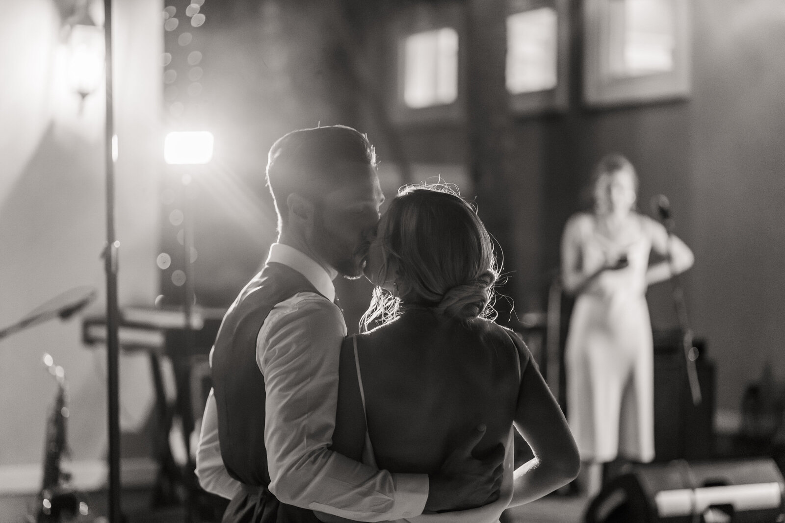 Bride and groom kiss in black and white in Chattanooga at their reception