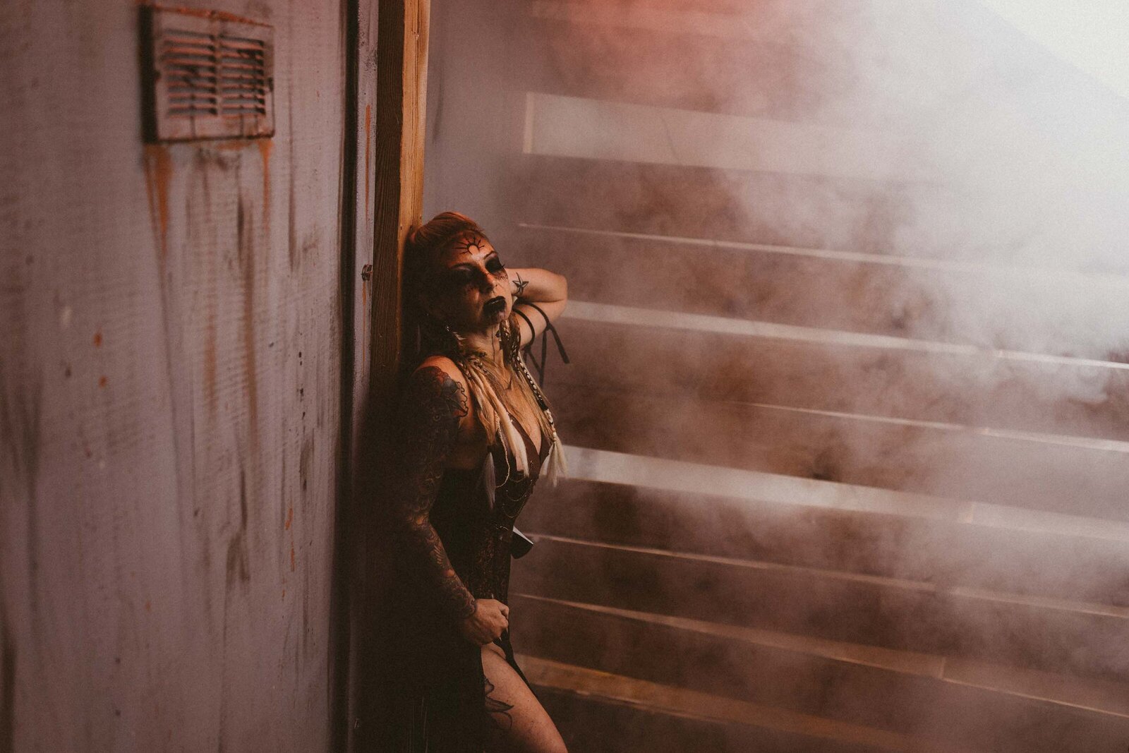scary woman leaning on the wall with smoke effect