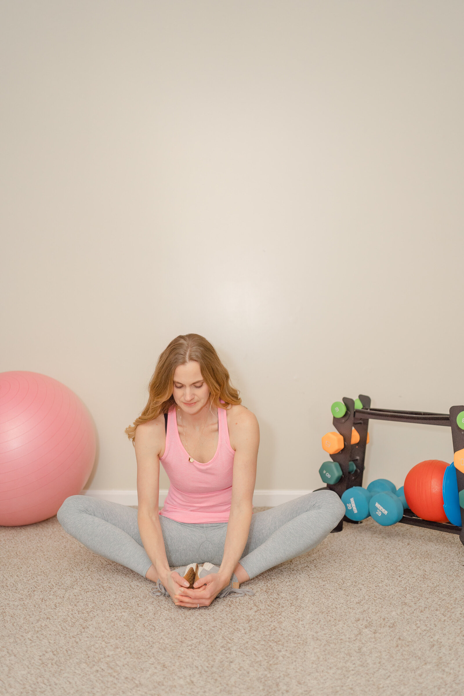 fitness coach stretching her legs taken by Chantilly,Virginia branding photographer