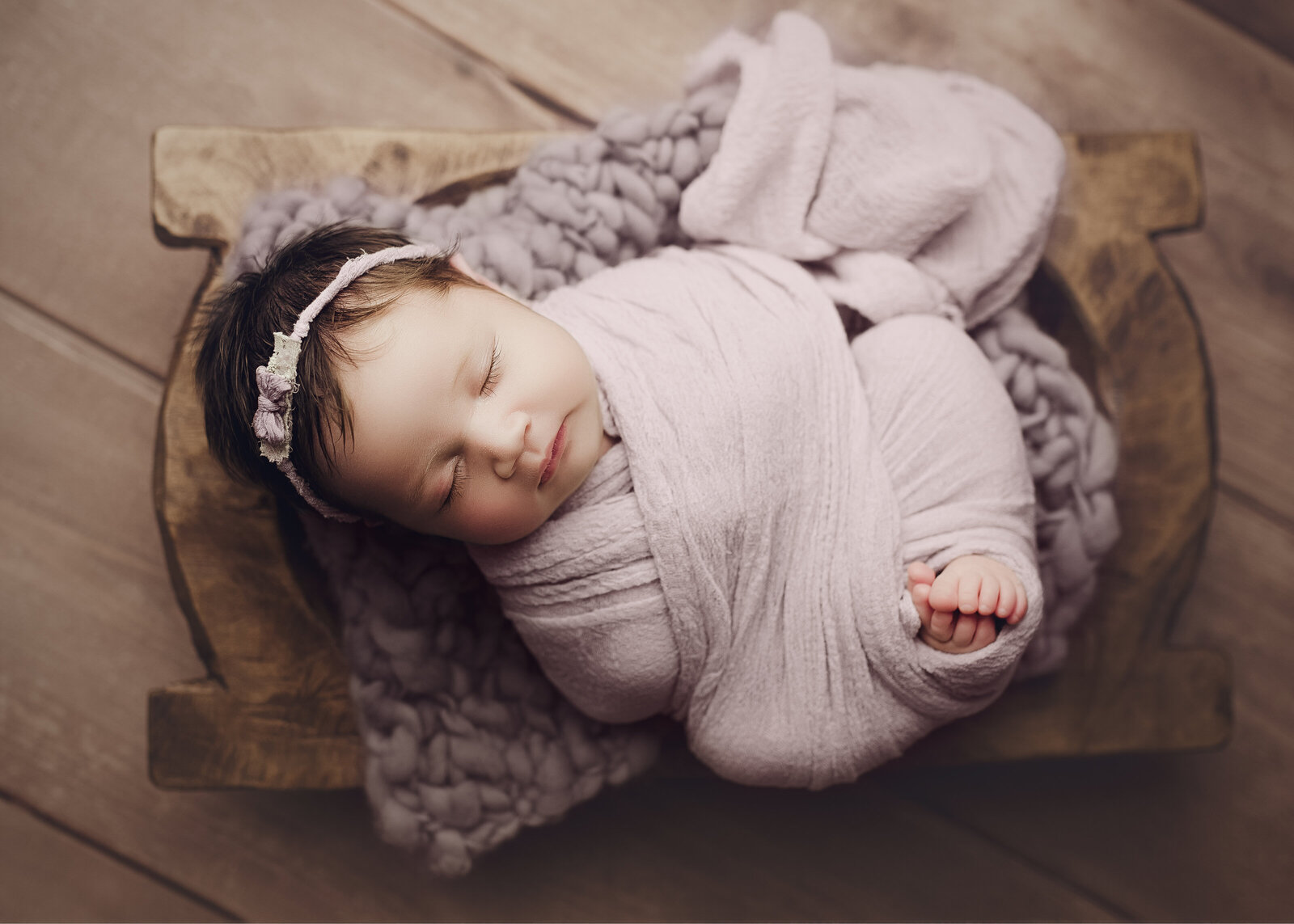 so perfectly wrapped and sleeping peacefully in purple. her little toes sticking out. Blueberry and lace photography