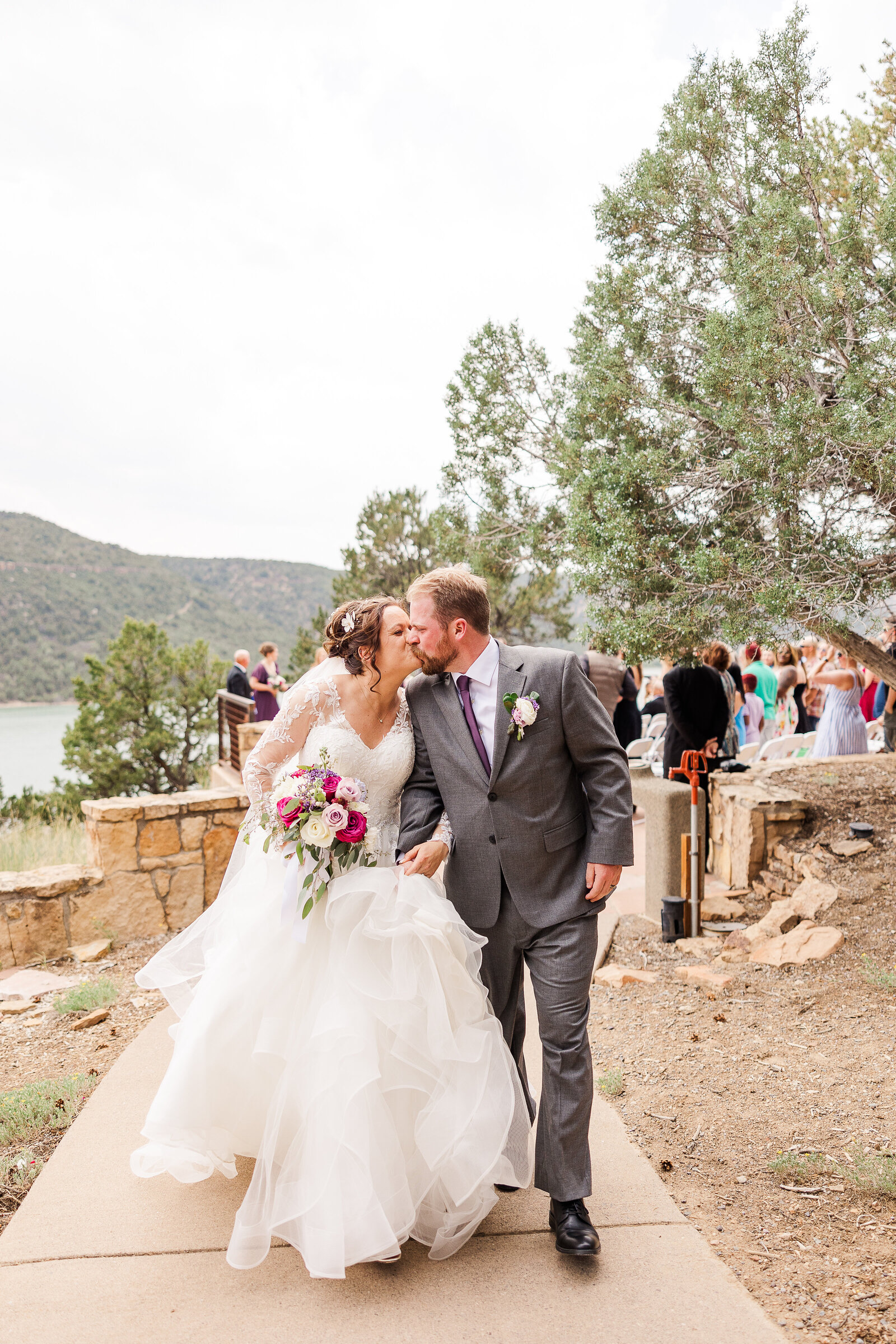 Bride and groom walking back down the aisle after their ceremony at a Ridgway State Park wedding, celebrating their first moments as newlyweds