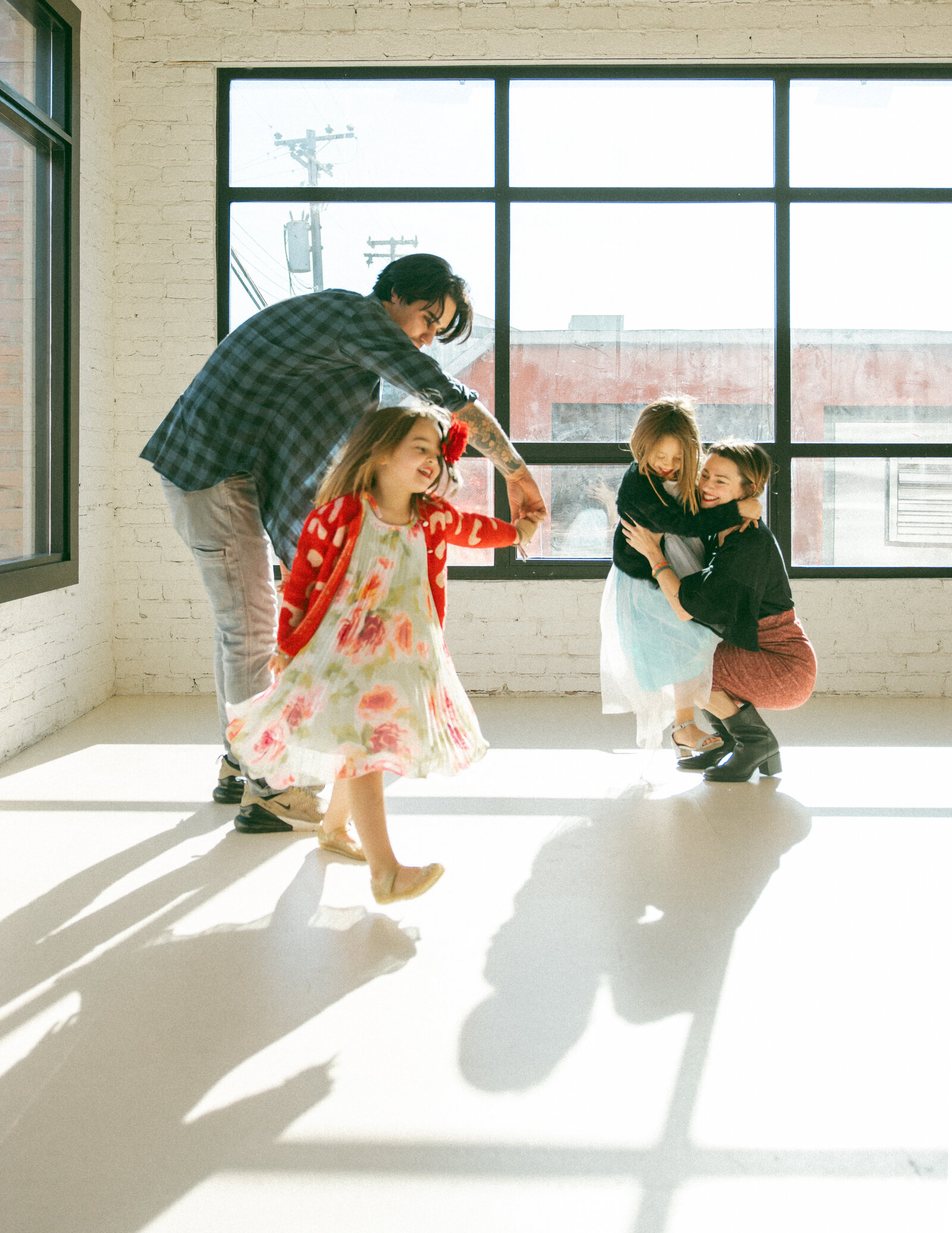family of four dancing in a photo studio