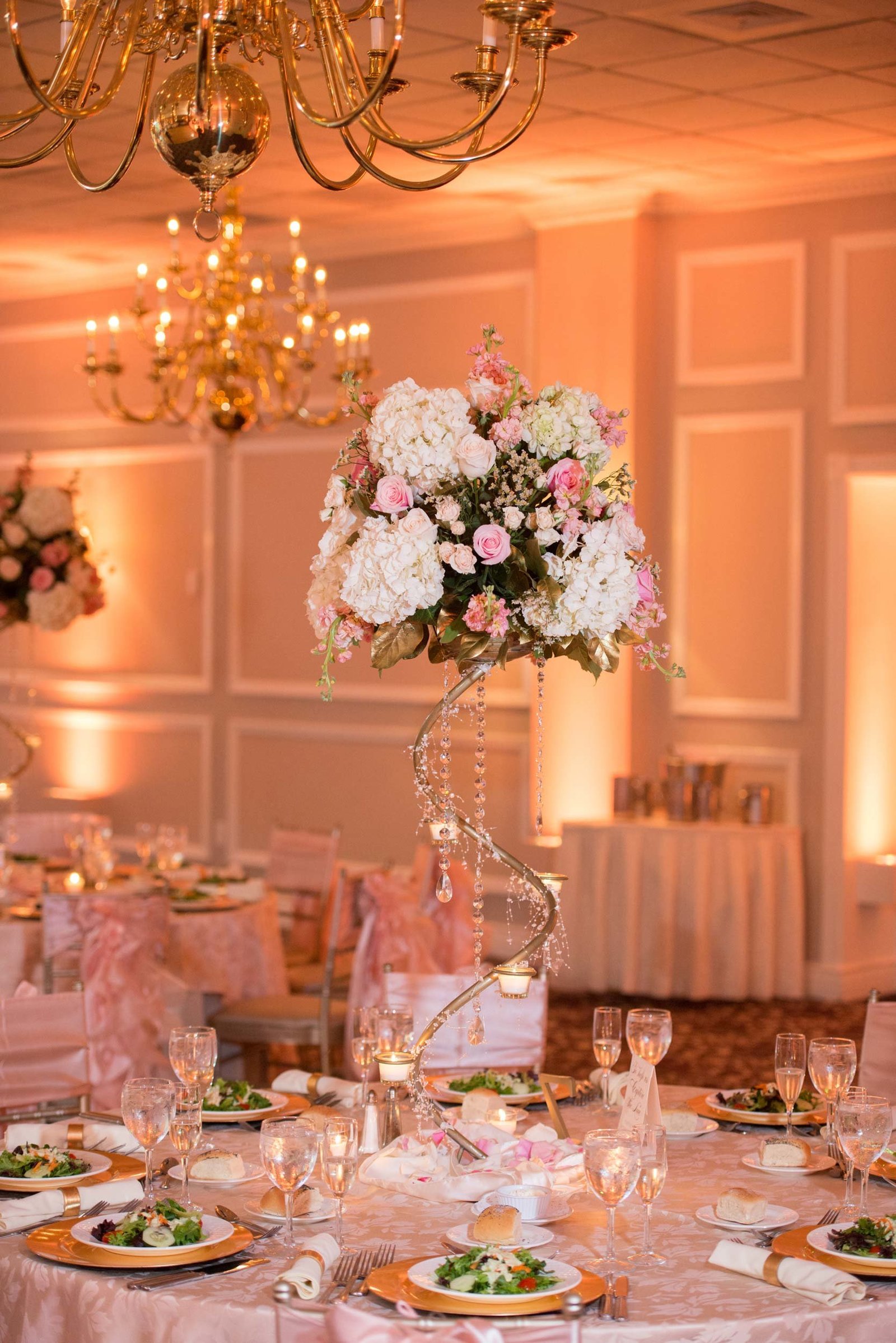 Centerpiece with white flowers and gold stand  at East Wind