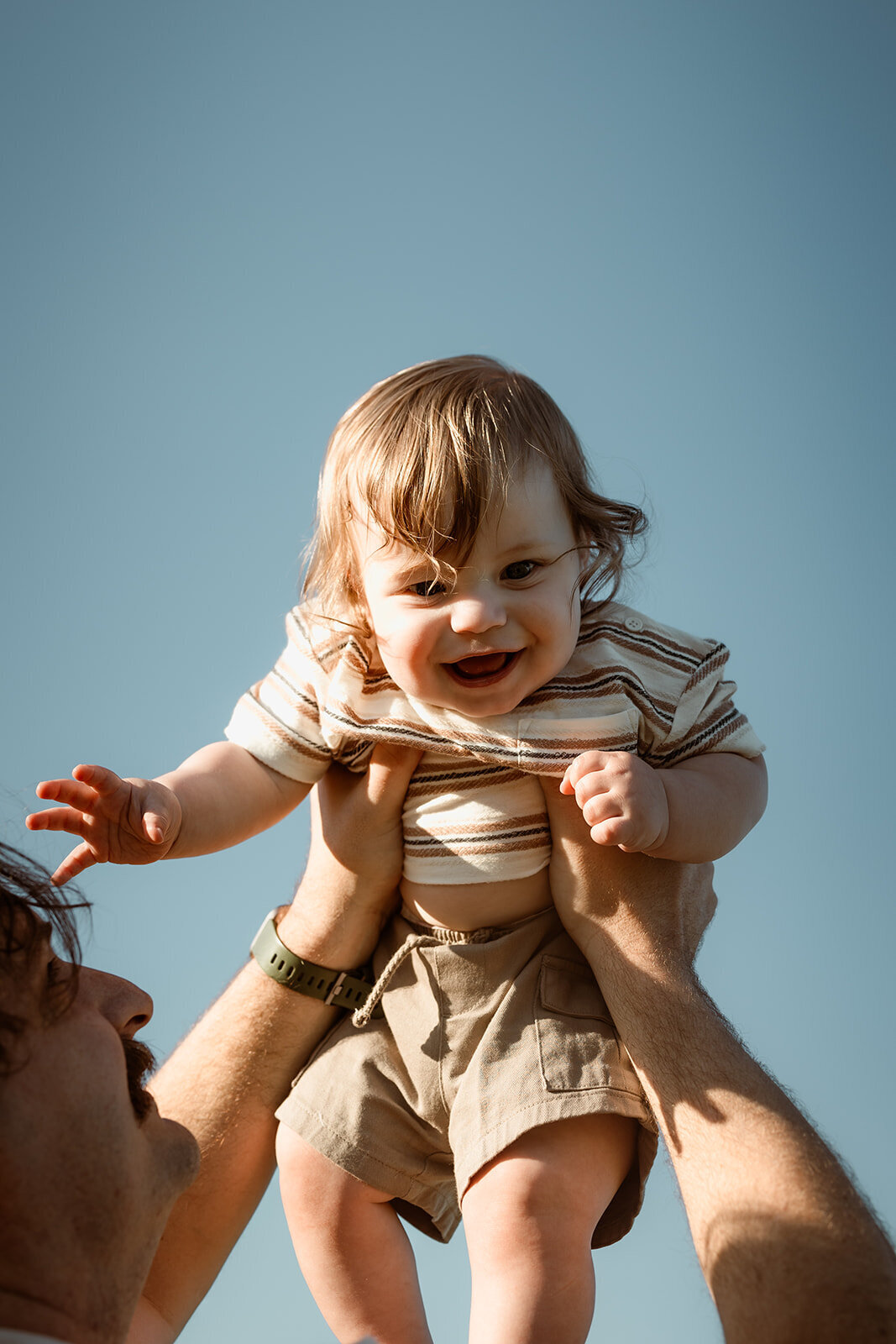 son flying through the air with his father, cuddles and love