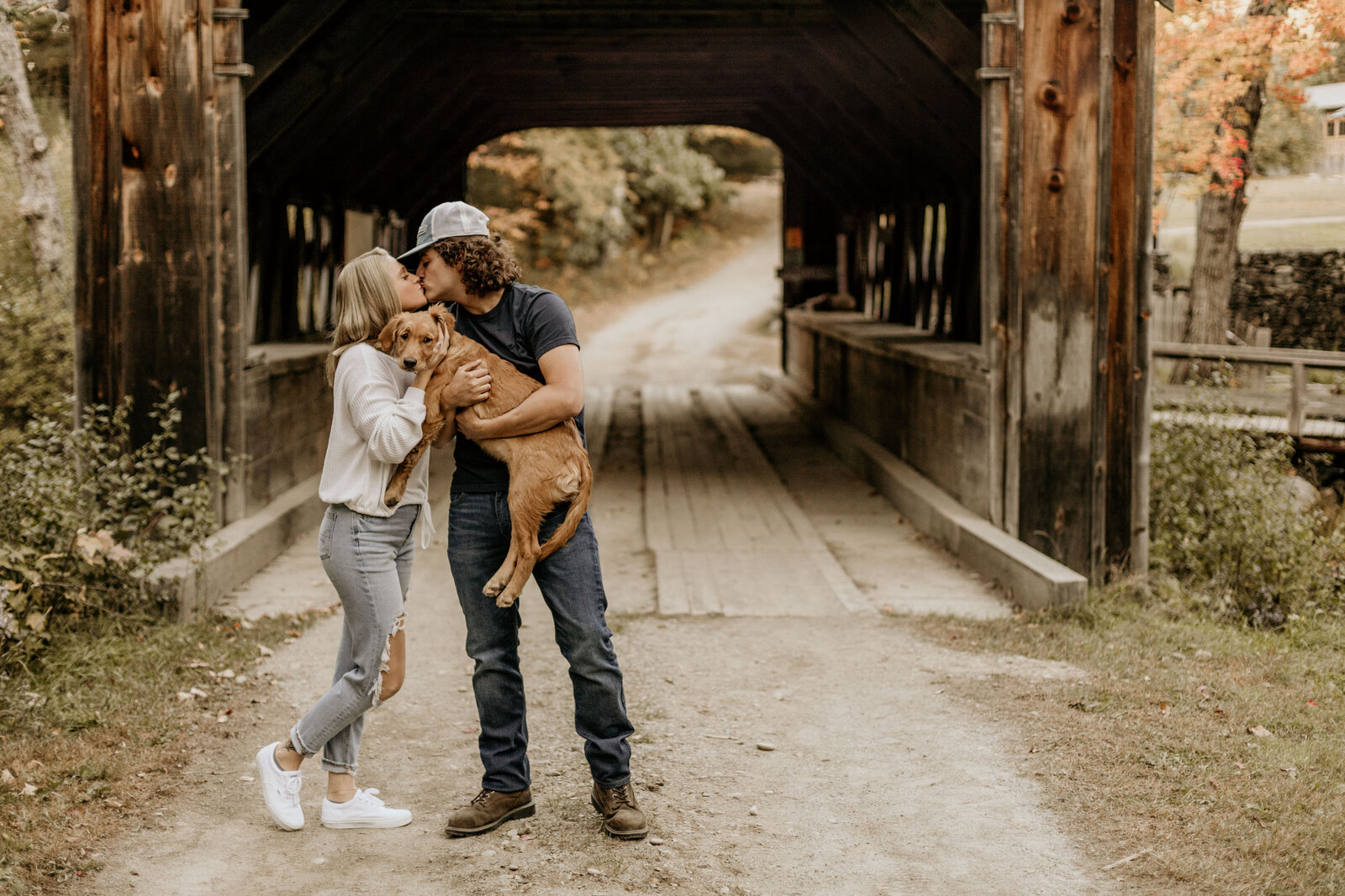 Couples portrait with  golden retriever, located at