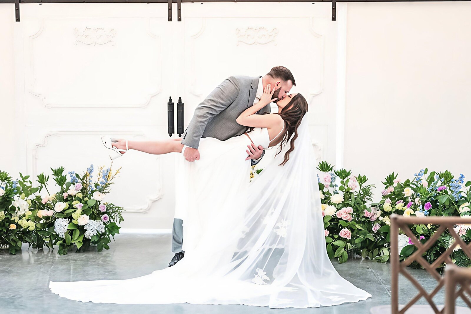 Bride-Groom-Kissing-Sliding-Barn-Doors-The-Legacy-at-Willow-Pond.JPG