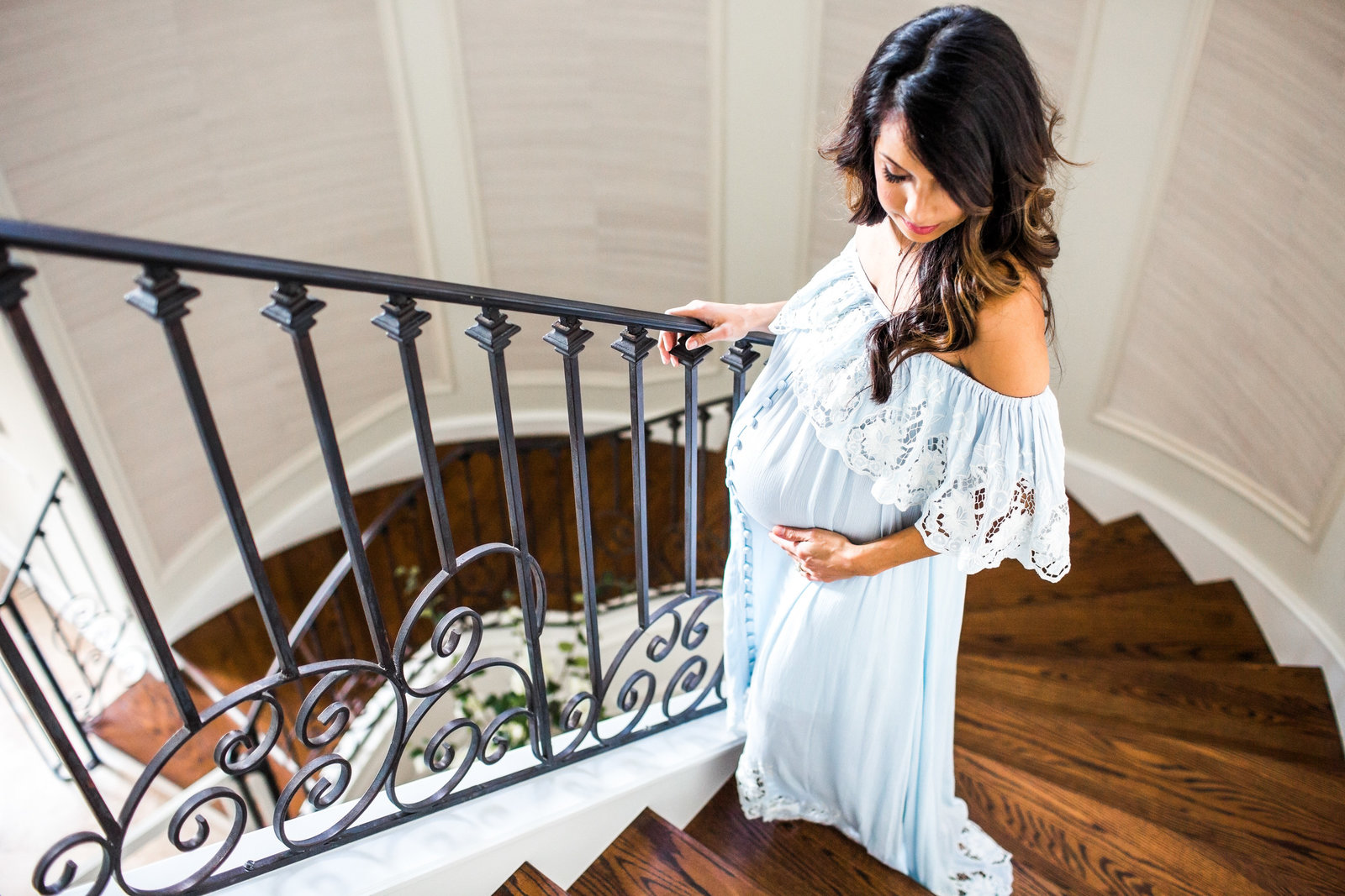 Maternity pictures on staircase in bohemian off the shoulder dress